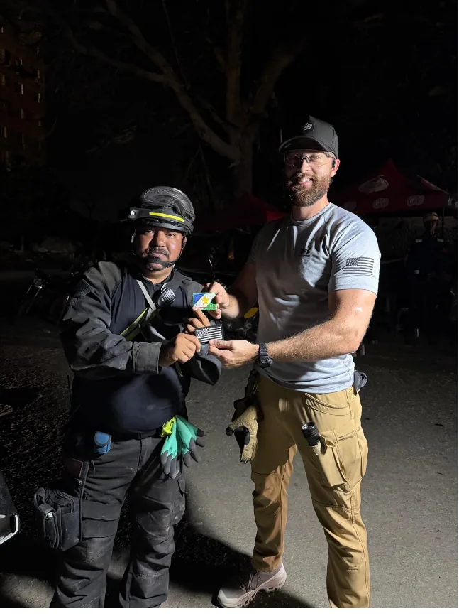 Exchanging unit insignia with a search and rescue team member